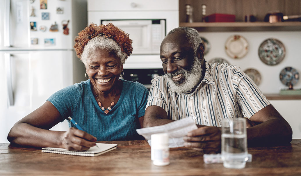 Senior couple smiling while taking medication